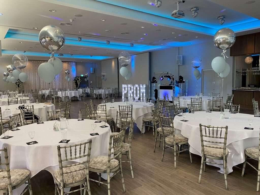 School prom celebration in the Garden Suite featuring blue and silver balloons and PROM display.