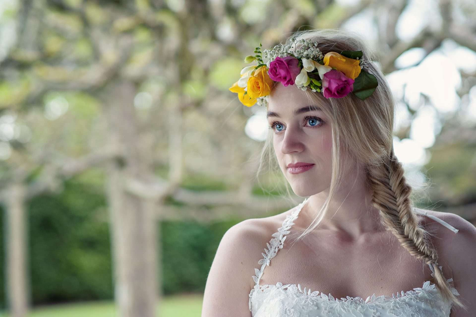 Bride wearing a colourful flower crown before her wedding at Greenwoods Hotel in Essex