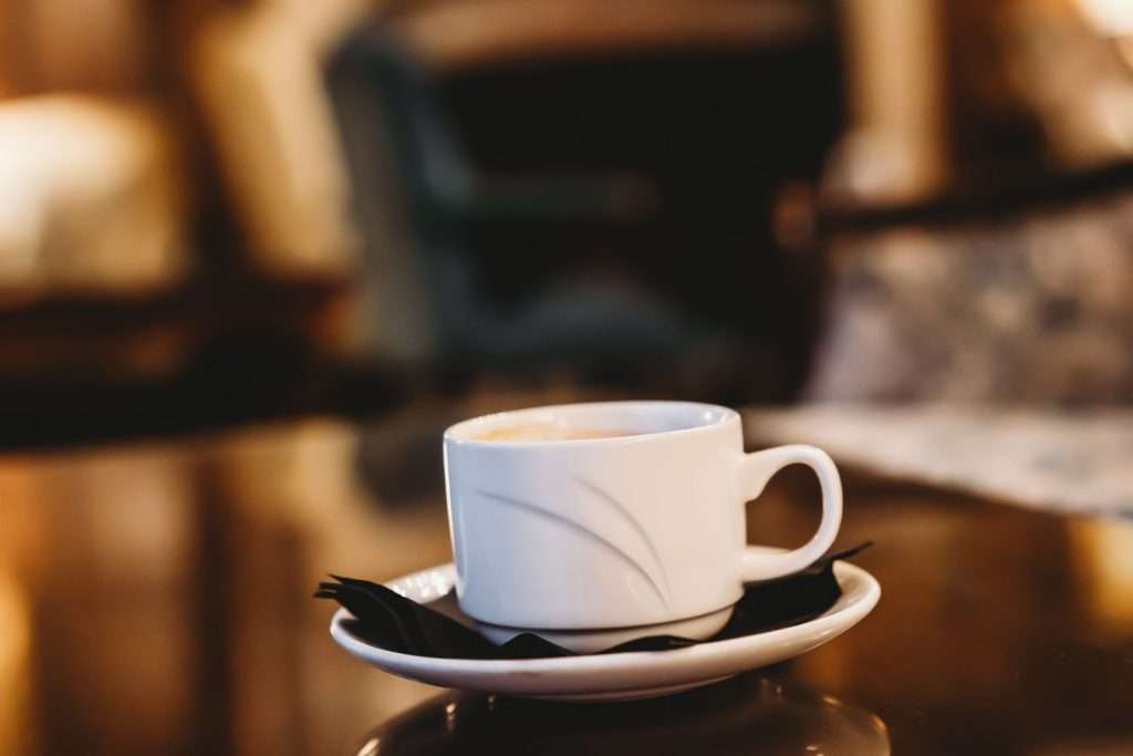 Close-up of a coffee cup in the elegant Lounge Bar at Greenwoods Hotel in Essex, perfect for afternoon relaxation and drinks.