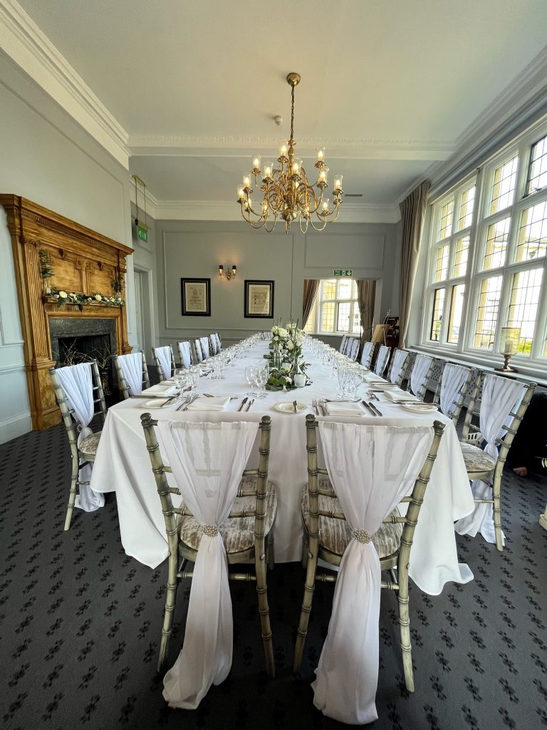Long dinner table styled for a special celebration in the Library Suite at Greenwoods Hotel Essex