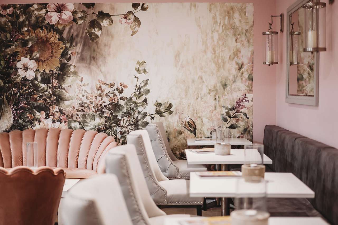 Detail of floral wallpaper and plush seating in Greenwoods Hotel spa lounge