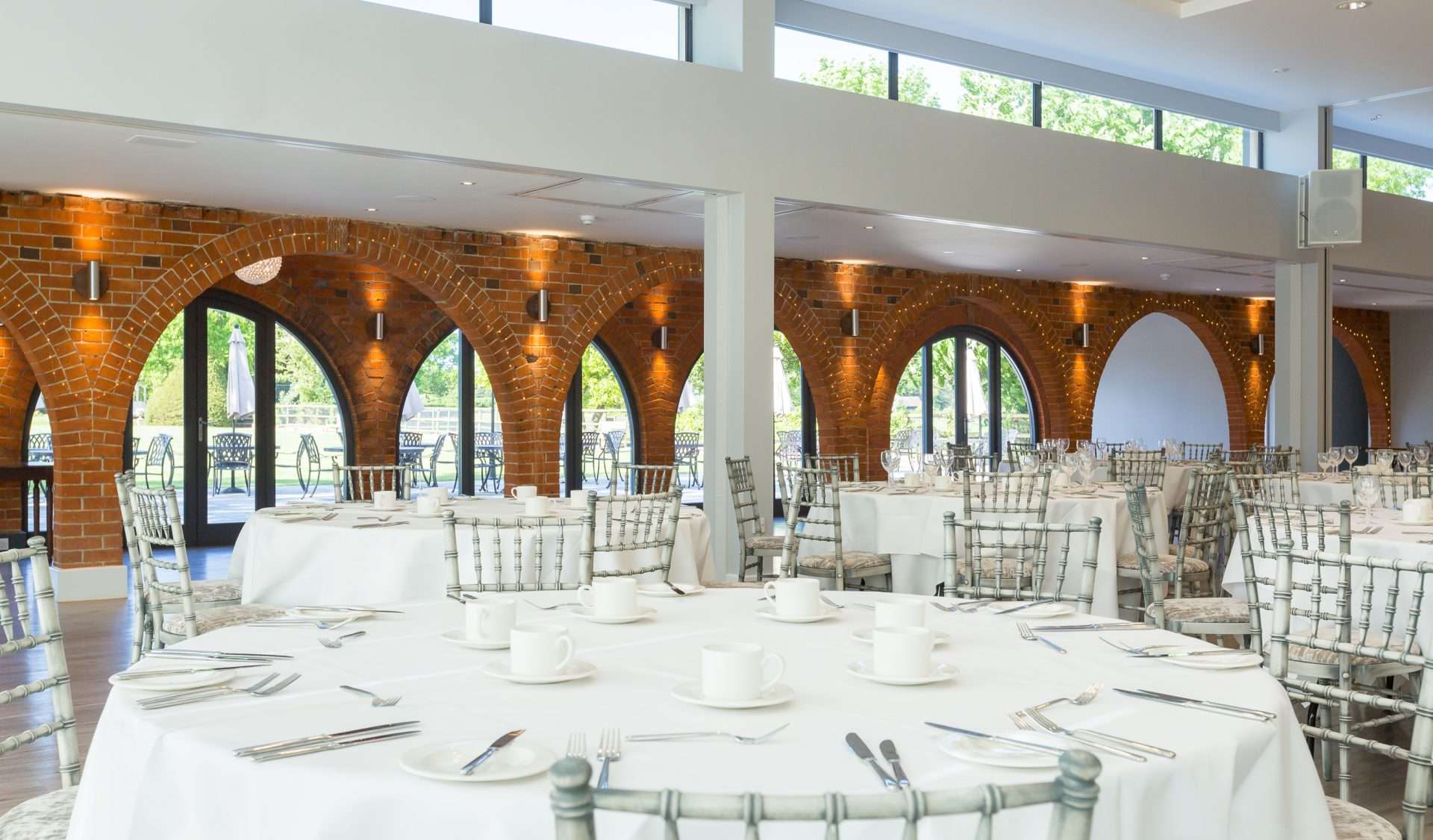 Half room layout of the Garden Suite with natural light and arched brick features.