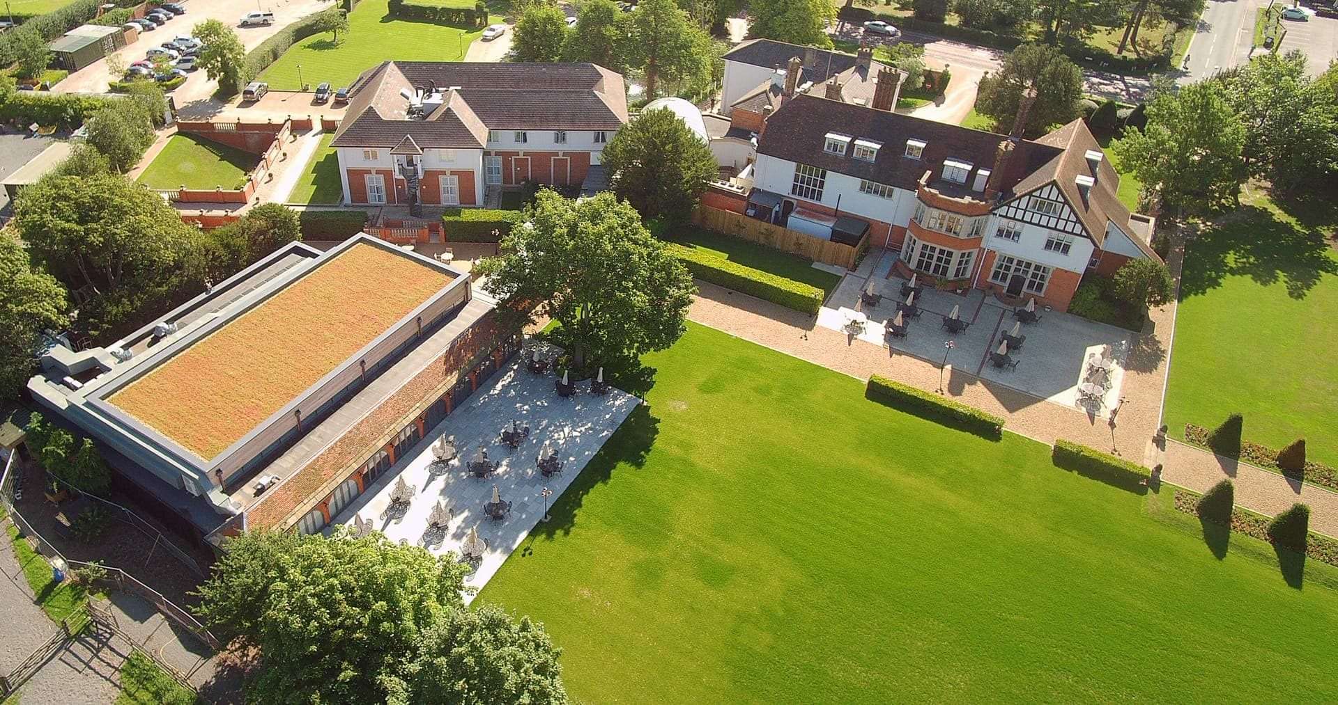 Drone shot of Greenwoods Hotel rear with garden layout and buildings