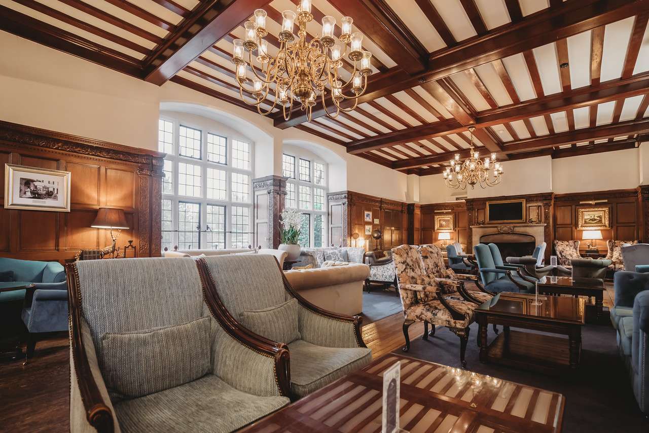 Elegant lounge seating area at Greenwoods Hotel with classic furnishings and large windows