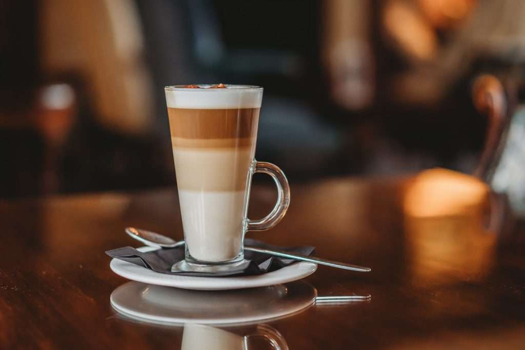 A beautifully served latte on a table in the Greenwoods Hotel Lounge Bar, perfect for relaxing in style in Essex.