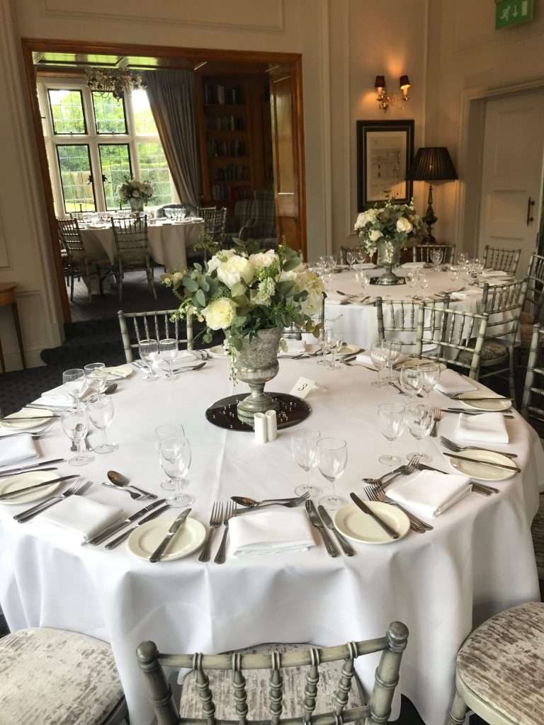 Room setup in the Library Room at Greenwoods Hotel with round tables arranged for a private celebration or baby / bridal shower.