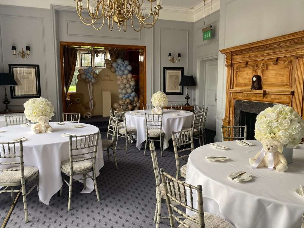 Baby shower event in the Library Suite at Greenwoods Hotel featuring round tables, teddy bear floral centrepieces and balloon display.