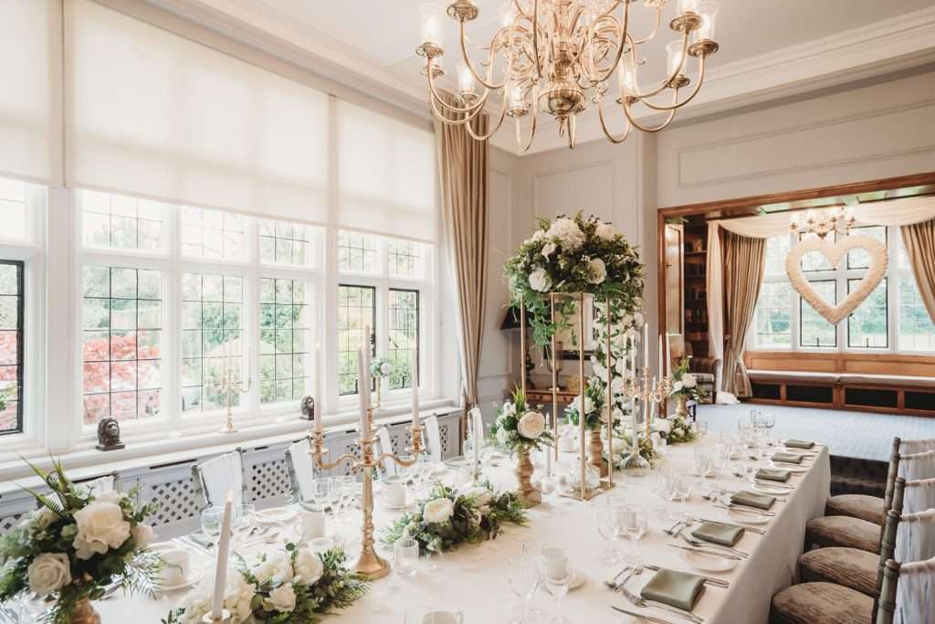 Bridal shower setup in the Library Suite at Greenwoods Hotel with elegant floral centrepieces and heart-shaped window décor.