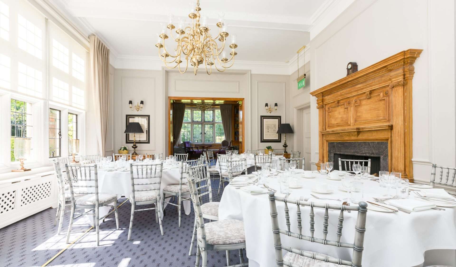 Three round tables arranged in the Library Suite for private functions and special occasions at Greenwoods Hotel & Spa, Essex.