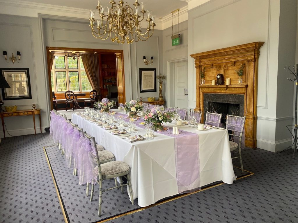 Elegant long table decorated for a birthday or anniversary celebration at Greenwoods Hotel in the Library Suite