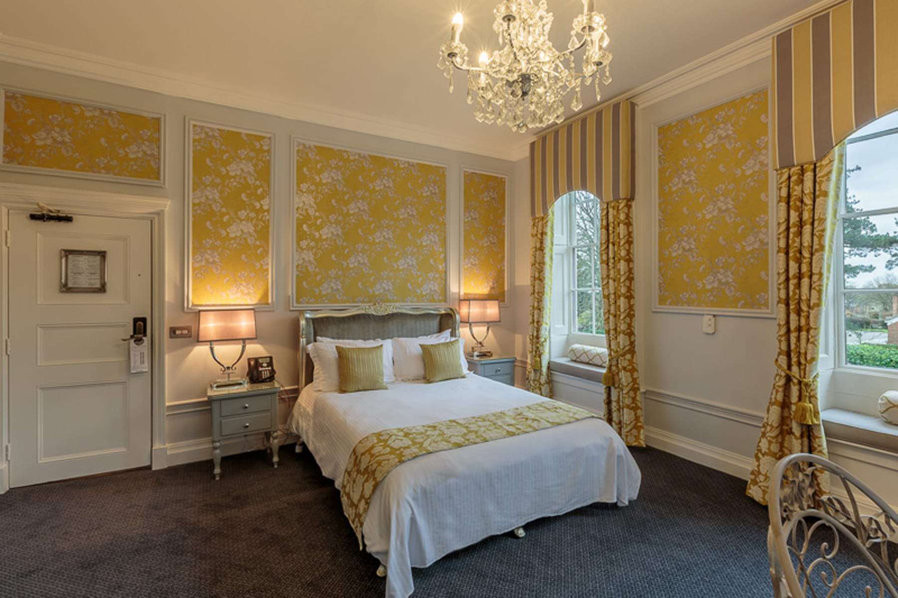 Premier hotel room at Greenwoods featuring yellow décor panels and luxury furniture