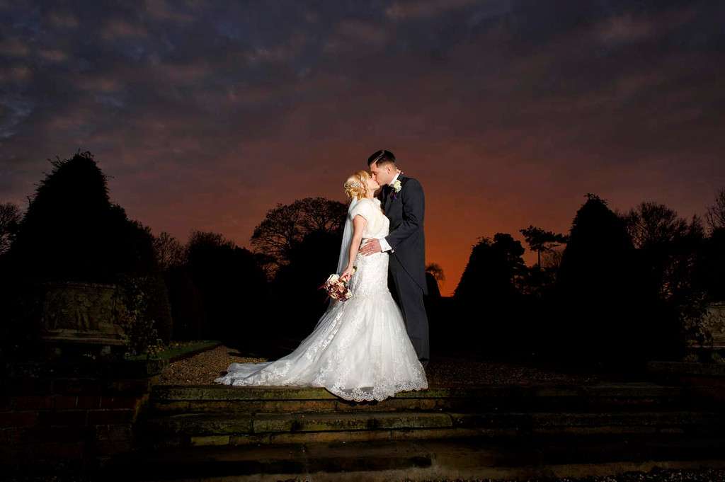 Bride and groom photographed at sunset in the Greenwoods Hotel gardens during their Essex wedding