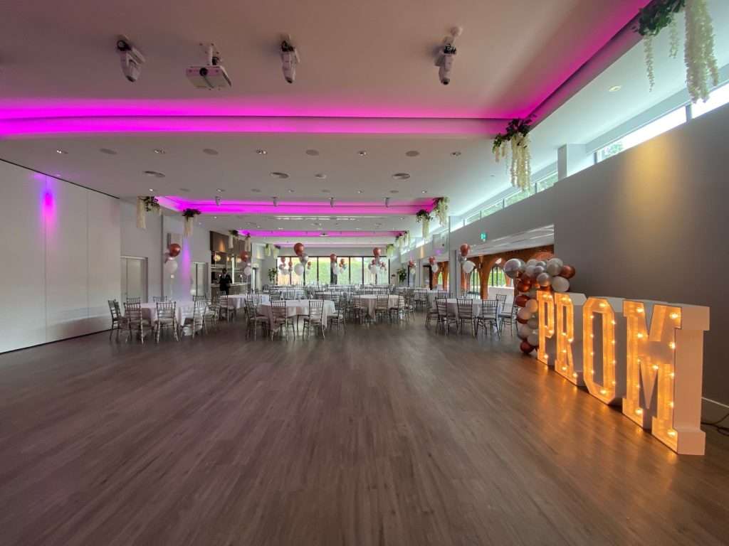 Wide-angle view of the Garden Suite arranged for a school prom with illuminated PROM letters.
