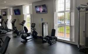 Strength training area in the hotel gym at Greenwoods Hotel & Spa with resistance machines and free weight equipment