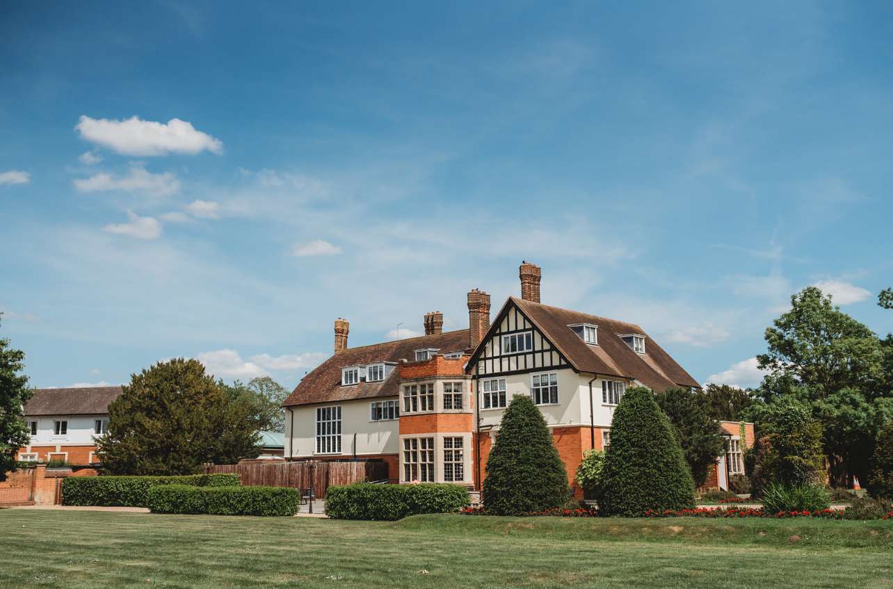 Exterior view of the manor house and lawns at Greenwoods Hotel and Spa, an Essex wedding venue.