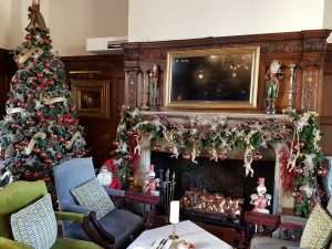Festive Christmas fireplace and decorated manor house lounge at Greenwoods Hotel & Spa, ideal for winter weddings in Essex