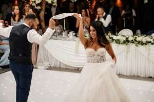 Bride and groom enjoying their first dance on a white dance floor during a dry hire wedding reception at Greenwoods Hotel and Spa.