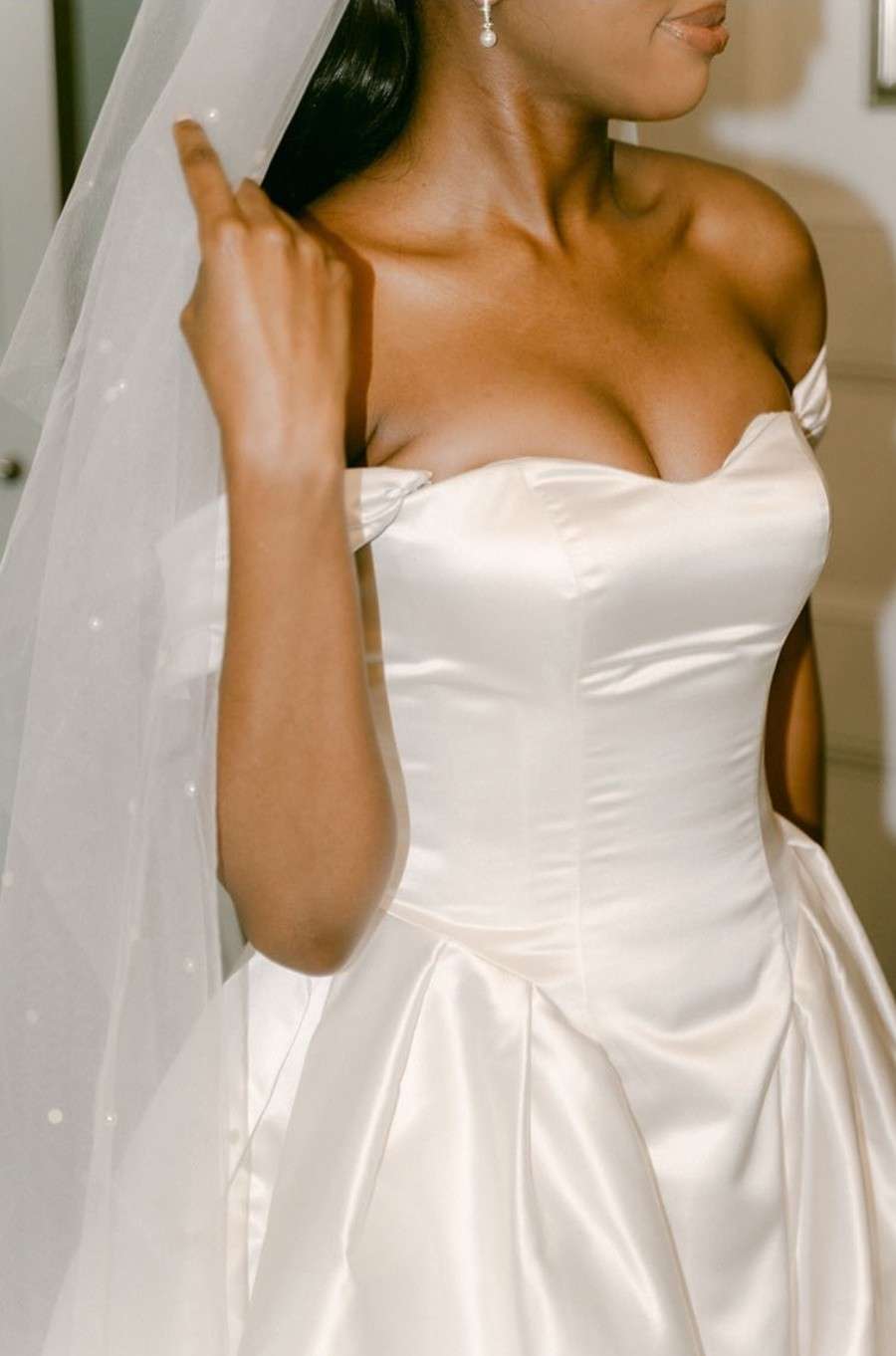 Close-up of a bride in an elegant satin wedding dress, ideal for a Greenwoods Hotel wedding gallery.