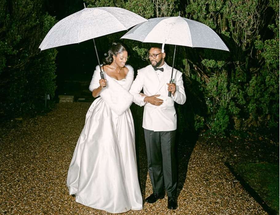 Wedding couple holding umbrellas during an evening portrait at Greenwoods Hotel & Spa in Essex.