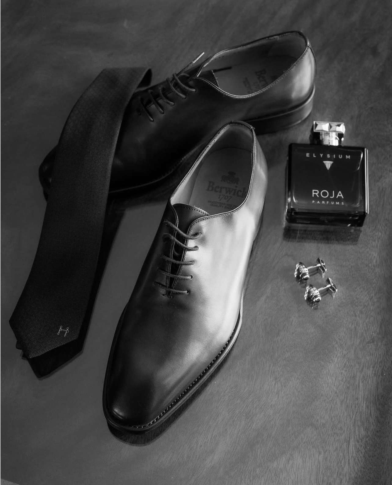 Groom details including formal shoes, tie, cufflinks and fragrance prepared before a wedding at Greenwoods Hotel and Spa.