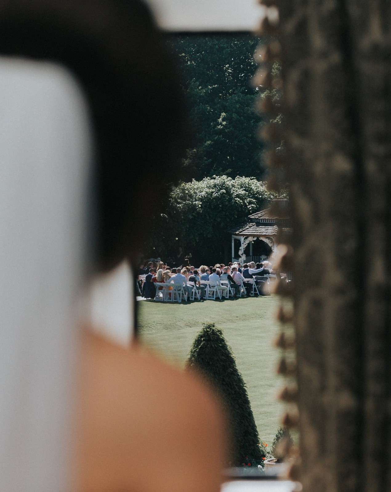 View of an outdoor wedding ceremony in the gardens at Greenwoods Hotel and Spa.