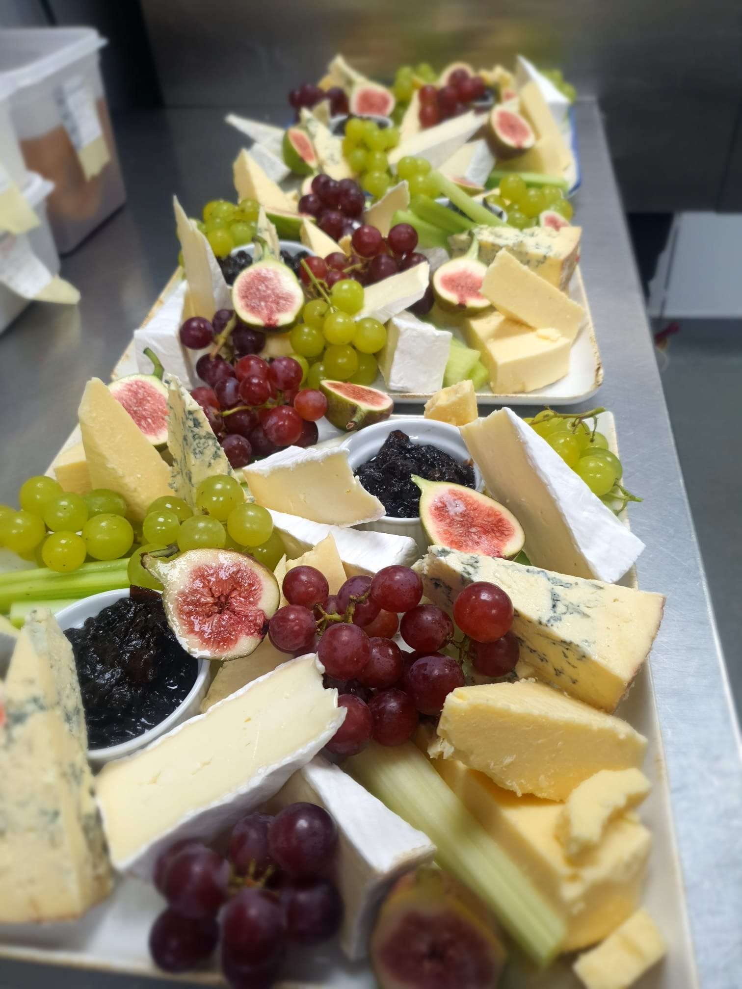 Cheese board selection with grapes, figs, chutney and celery prepared for wedding catering at Greenwoods Hotel and Spa.
