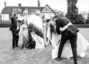 Bride, groom and wedding party celebrating on the lawns at Greenwoods Hotel and Spa.