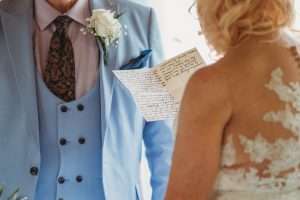 Close-up of handwritten wedding vows being read during a ceremony at Greenwoods Hotel and Spa.