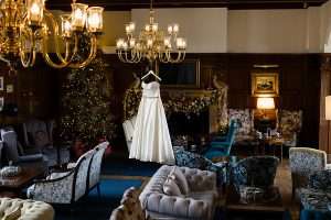 Wedding dress displayed in the festive manor lounge at Greenwoods Hotel & Spa, a romantic winter wedding venue in Essex.